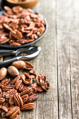 Peeled pecan nuts on wooden table.