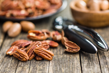 Peeled pecan nuts on wooden table.