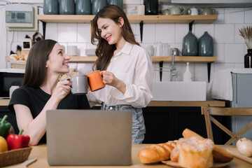 Young women enjoy talking while drinking milk in the kitchen in the morning concept.