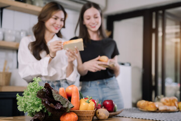 Young beautiful woman preparing breakfast cutting bread at the kitchen.