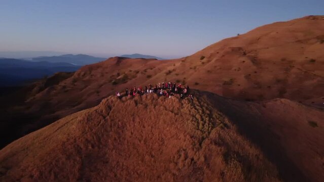 Aerial video of Mount Pulag at sunset with people in the background, the third highest mountain 