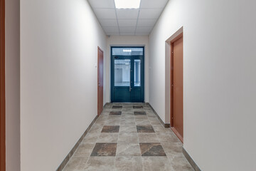 Obraz na płótnie Canvas white empty long corridor with red brick walls for room office in interior of modern apartments, office or clinic