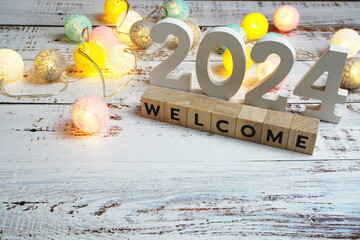 Welcome 2024 word alphabet letters on wooden background