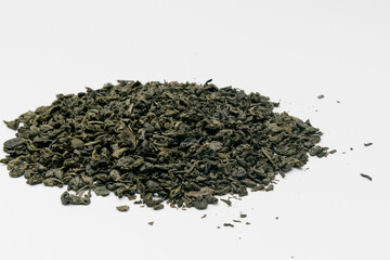 Heap of dry green tea isolated on white background