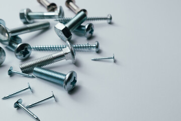 Set of bolts, screws, nails on a white background. Construction abstraction. Industrial background. Screws and bolts macro photo, screw background, steel screw, bolt macro.