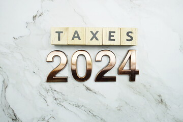 Taxes 2024 alphabet letter on marble background