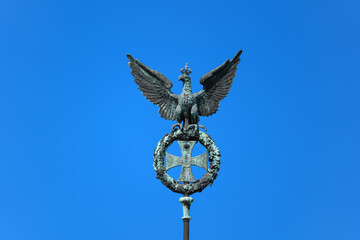 Fototapeta na wymiar Prussian Eagle And Iron Cross On Brandenburg Gate In Berlin