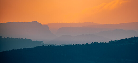 mountain ranges and red sky at sunset