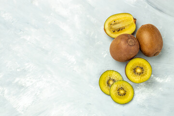 Golden kiwi fruit on a light background, banner, menu, recipe place for text, top view