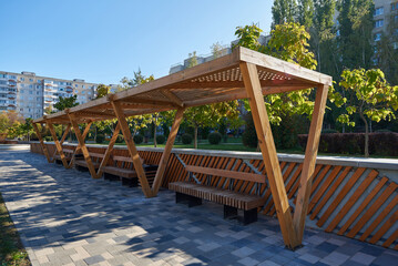 Benches with a canopy made of wood in the city park
