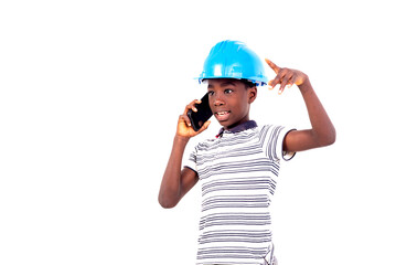 portrait of a young boy in a safety hat communicating on the cell phone.