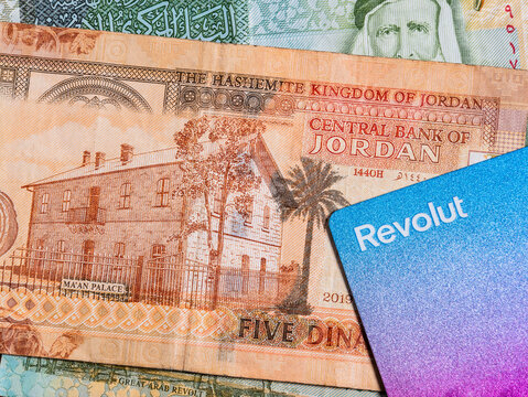 Bucharest, Romania  - 02.22.2023: Macro detail picture with 5 Jordanian dinar banknote and a Revolut credit or debit card. JOD is the official currency in The Hashemite Kingdom of Jordan