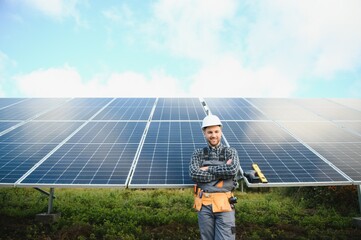 Professional worker installing solar panels on the metal construction, using different equipment,...