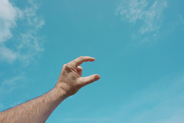 hand up gesturing in the blue sky, feelings and emotions