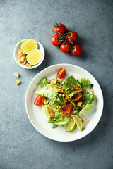 Healthy green salad with cherry tomatoes and peanut