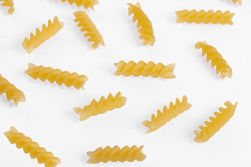 Pasta products in the form of a spiral, texture, on a white background