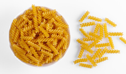 Pasta products in the form of a spiral on a plate, texture, on a white background