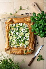 Zucchini and cheese phyllo dough tart with green peas, micro greens and basil. Zucchini and feta...