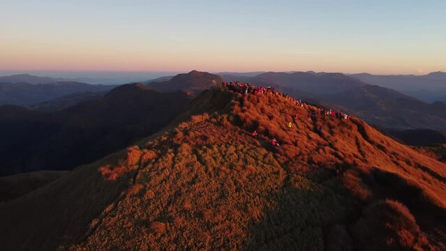 Aerial video of Mount Pulag at sunset with people in the background, the third highest mountain 