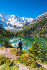 Hiker in Aviolo lake, Adamello natural park in Brescia province, Lombardy district, Italy.