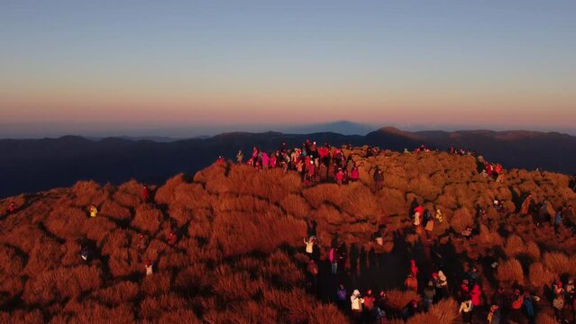 Aerial video of Mount Pulag at sunset with people in the background, the third highest mountain 