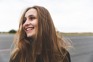 Happy woman with long hair portrait outdoors