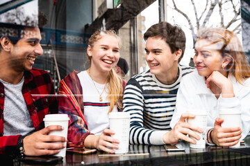 Happy multiracial friends in a cafe in London