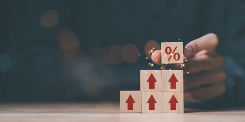 increase in interest rates, Financial concept, interest burden ,percentage increase in debt, Financial concept and business profit growth, Dividends , Retirement returns ,Wooden blocks in human hands