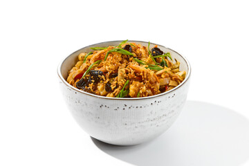 Asian fried noodles with shiitake mushrooms and vegetables isolated on white background Chinese fried noodles in vegetarian style in ceramic bowl. Stir-fry udon with vegetables and mushrooms