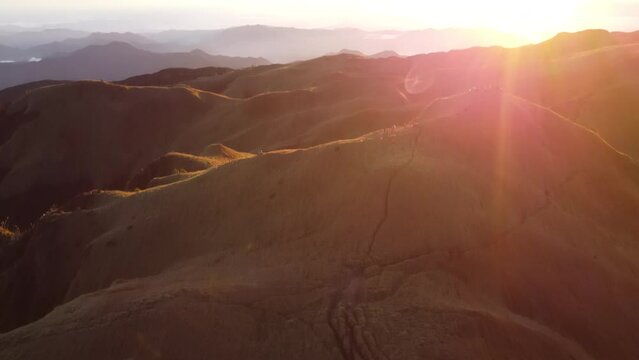 Aerial video of Mount Pulag at sunset with people in the background, the third highest mountain 