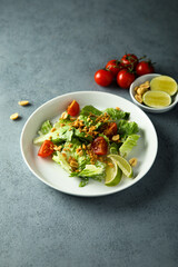 Healthy green salad with cherry tomatoes and peanut