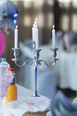 White candlestick with candles on a table