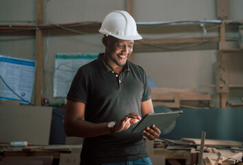 Close up focused African craftsmen working on his tablet creating designs