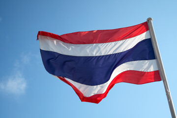 Fototapeta na wymiar Thailand flag waving in wind with blue sky