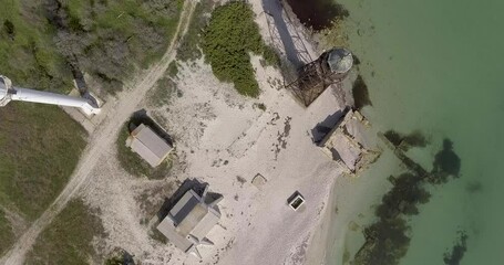 An old lighthouse designed by architect Alexander Gustav Eiffel on the Dzharylgach island in the Black Sea near the city of Skadovsk, Ukraine, next to a modern lighthous