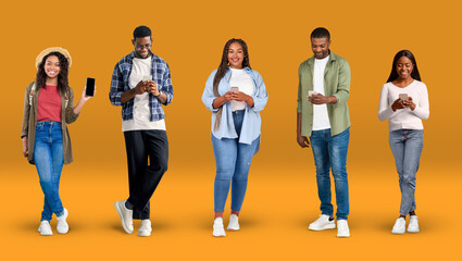 Cheerful young african american people in casual typing on phones, show phone with blank screen
