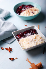 Typical Peruvian dessert: rice pudding and purple mazamorra on a light blue background.