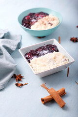 Typical Peruvian dessert: rice pudding and purple mazamorra on a light blue background.