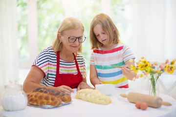 Mom and child baking bread.