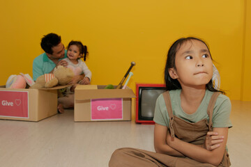 Stressed mother looks at little daughter worried about family problems sad all the time standing...