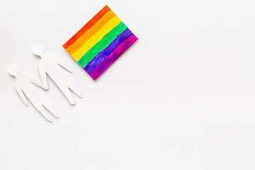 Gay pride rainbow LGBT flag with men couple paper shapes. LGBT social rights concept.