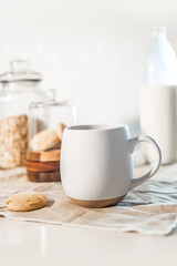 Fototapeta na wymiar cookies and morning drink, coffee, milk or tea in light natural envoronment, kinfolk style breakfast