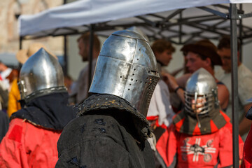 Fototapeta premium Historical restoration of knightly fights. Summer time medieval festival .Festival of medieval culture in the old fortress with knightly battles.
