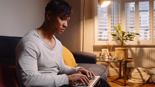 Close up Asian man typing laptop