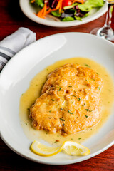 Italian Chicken Parmesan or parmigiana. Italian comfort dish. Chicken breast in breadcrumbs fried, topped with marinara sauce, melted mozzarella, parmigiana and provolone cheeses and Italian parsley. 
