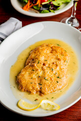 Italian Chicken Parmesan or parmigiana. Italian comfort dish. Chicken breast in breadcrumbs fried, topped with marinara sauce, melted mozzarella, parmigiana and provolone cheeses and Italian parsley. 