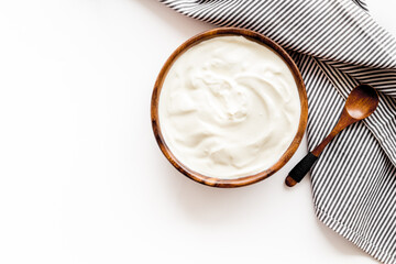 White dip sauce - sour cream or yogurt in wooden bowl