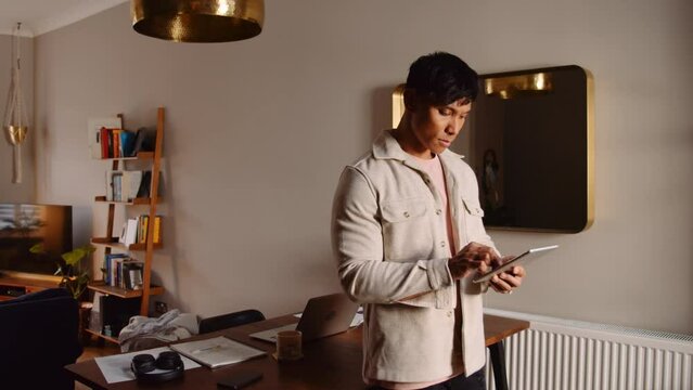 Asian man video call tablet