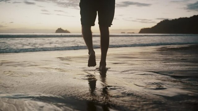 Man Walking Towards The Beach Barefooted. Slow Motion