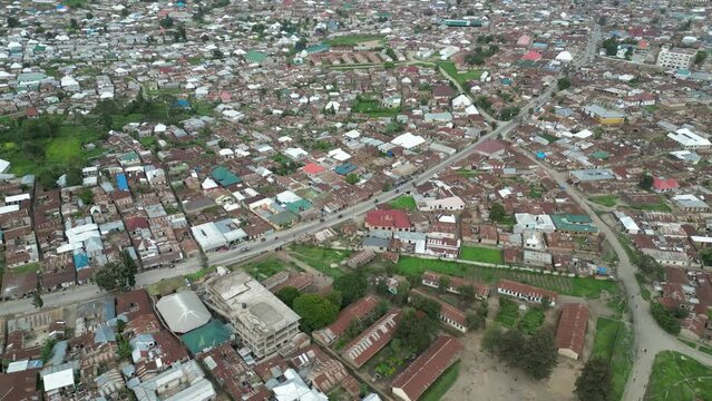 Aerial view of Mbeya city in Tanzania, Africa. Town is located in south west of Tanzania. Narrow highland valley surrounded by a bowl of high mountains.